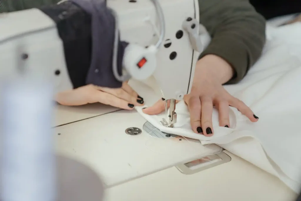 Image: person backstitching on a sewing machine
Backstitch