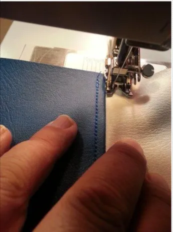 Original test photo showing the Singer 4423 easily sewing over four layers of thick denim. Highlights the low-friction Stainless Steel Bed Plate and high presser foot lift