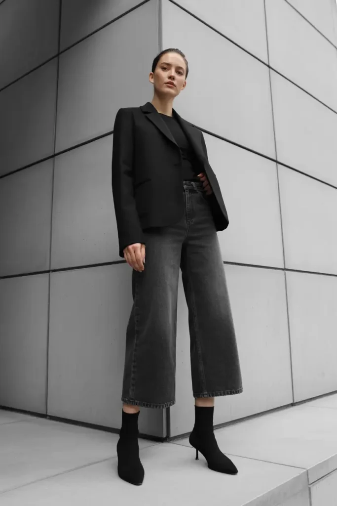 Sock boots styled with wide-leg cropped jeans creating a modern and fashion-forward boots and jeans outfit
